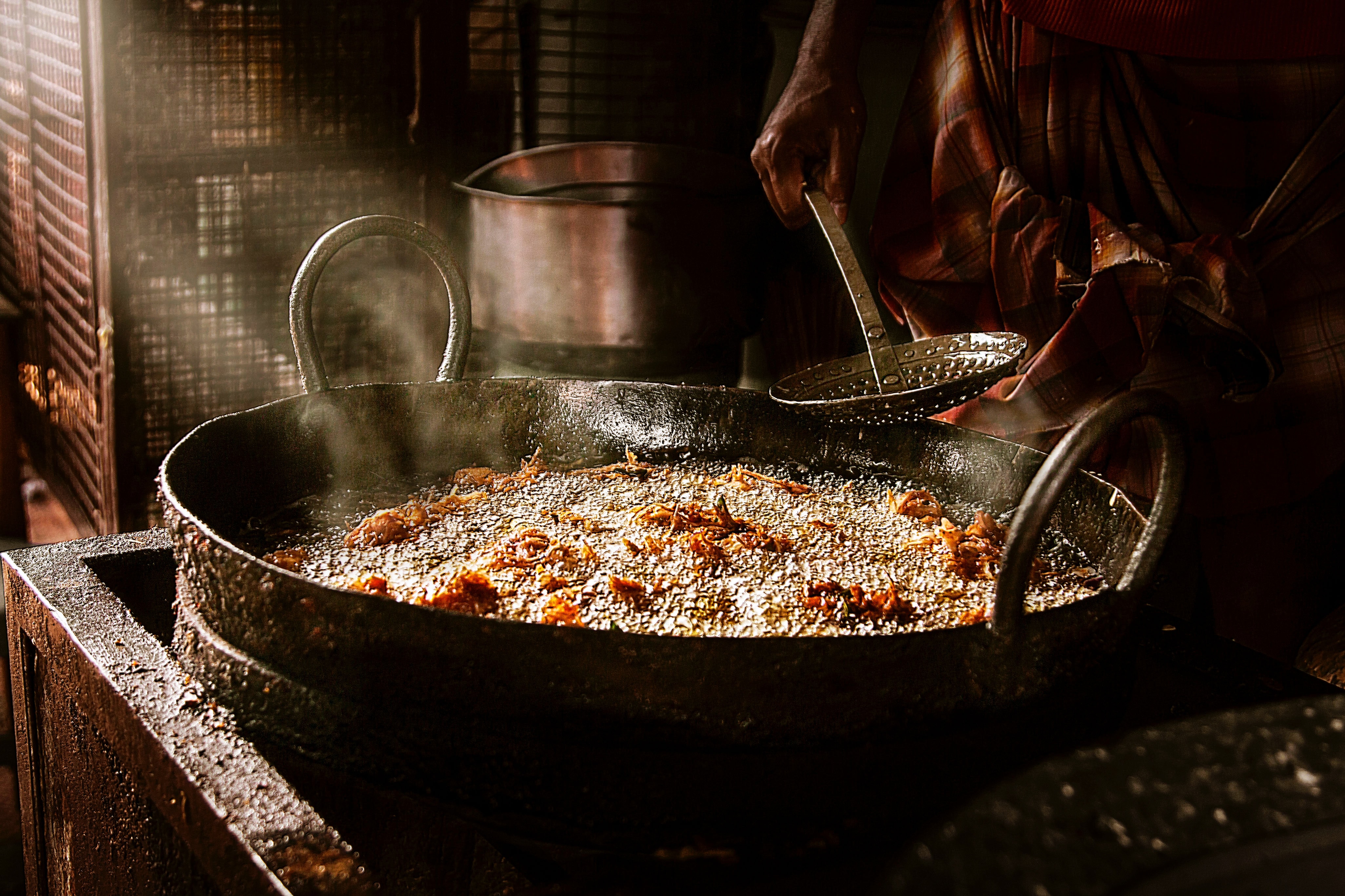 Person cooking in a large pot