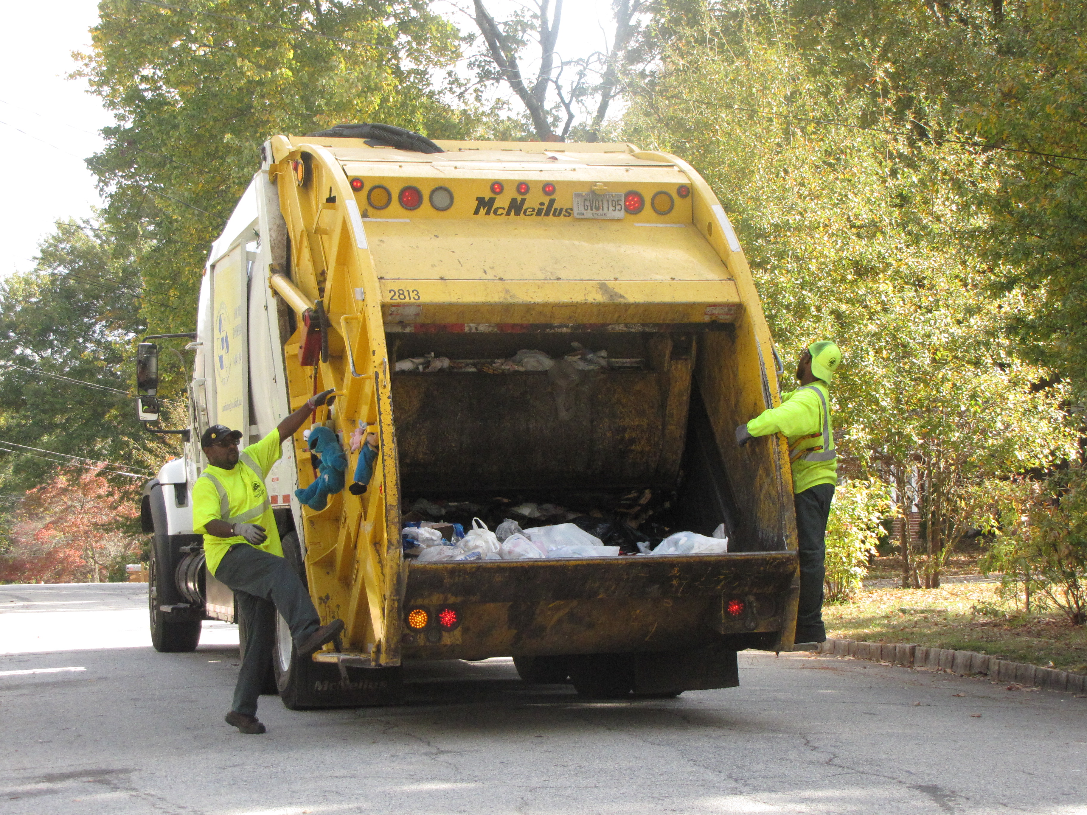 Sanitation workers collect refuse.