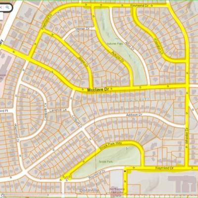 Map highlighting streets in bright yellow, featuring residential areas with intricate road patterns. Labels include McClave Dr, Raymond Dr, and nearby parks.