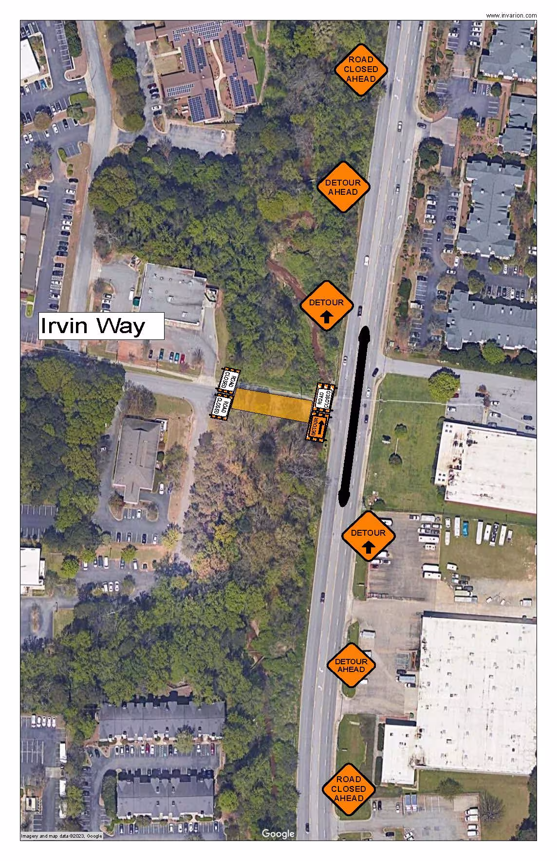 Aerial view of Irvin Way and adjacent road. Construction signs indicate road closure and detour. Buildings and greenery surround the area.