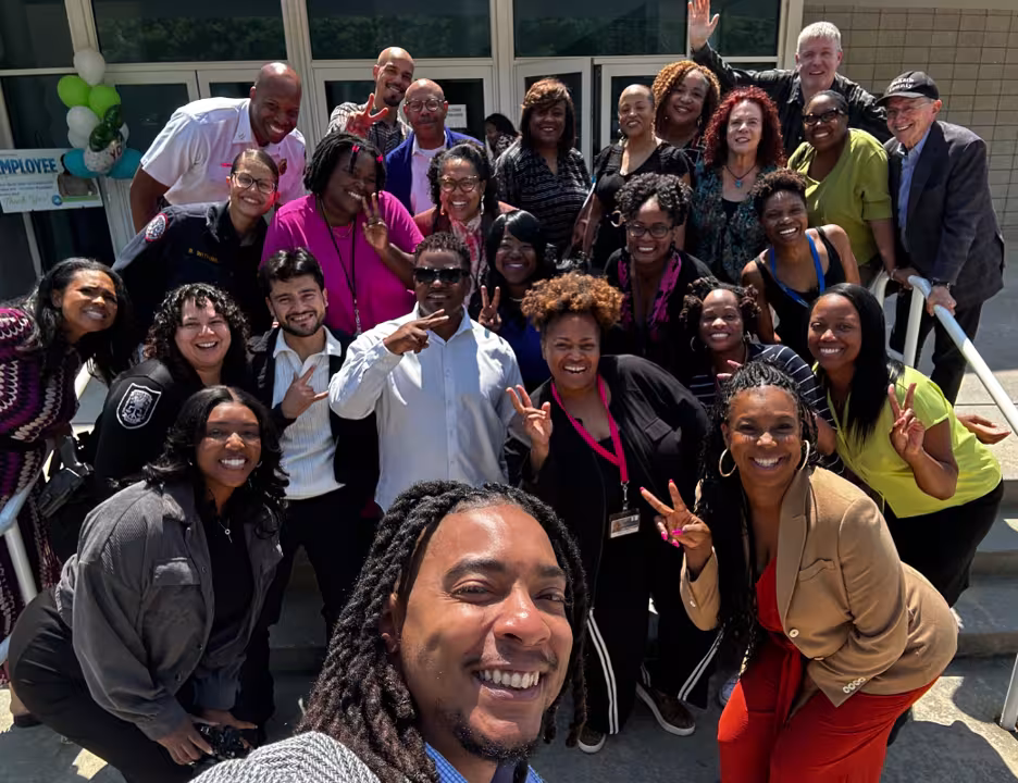 DeKalb County Communications Team poses together outside a county building, smiling and celebrating Employee Appreciation Day