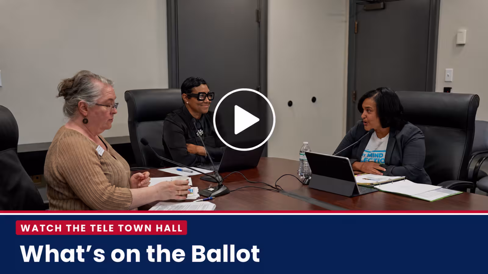 What’s on the Ballot” Tele Town Hall, featuring three women seated at a conference table during a discussion. A centered play button indicates a video link to watch the meeting on YouTube.