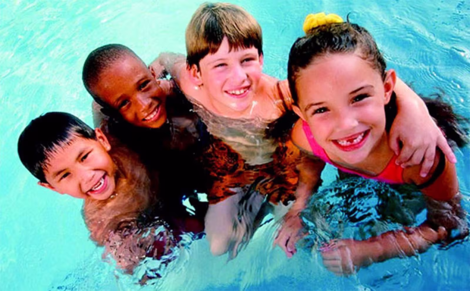 four kids in the swimming pool