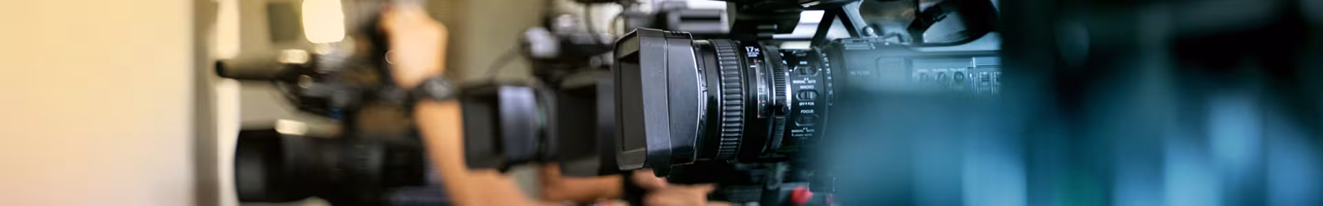Close up on four cameras filming for a news show.