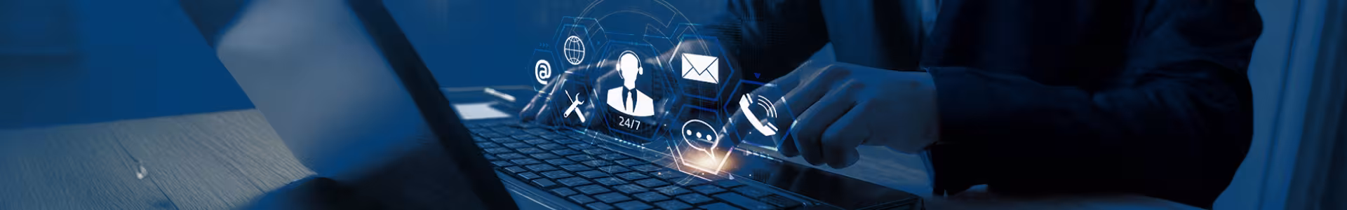 A person interacts with digital icons projected above a laptop keyboard, including cloud, email, and security symbols, representing technology and cybersecurity concepts.